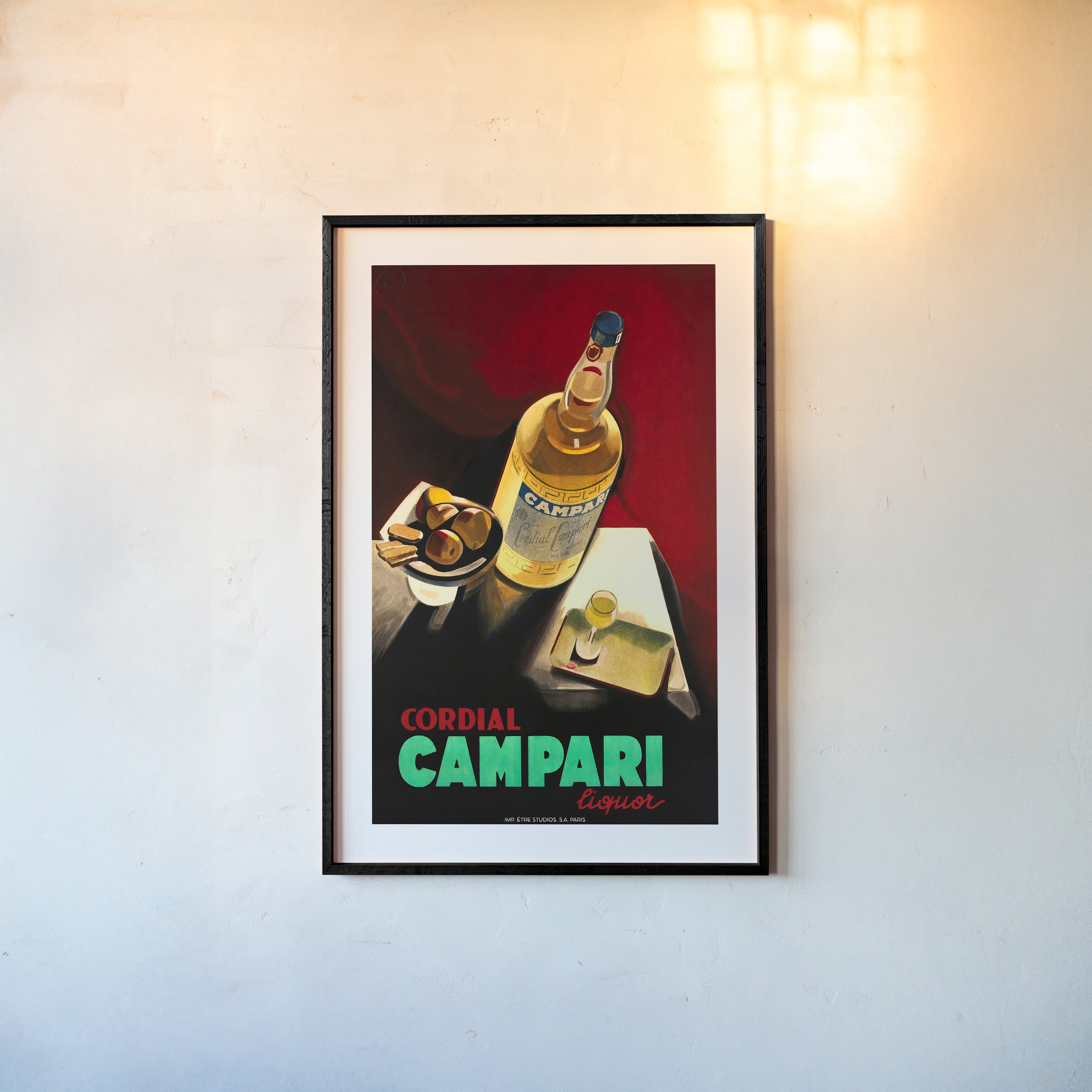 A framed poster features cordial Campari liquor
