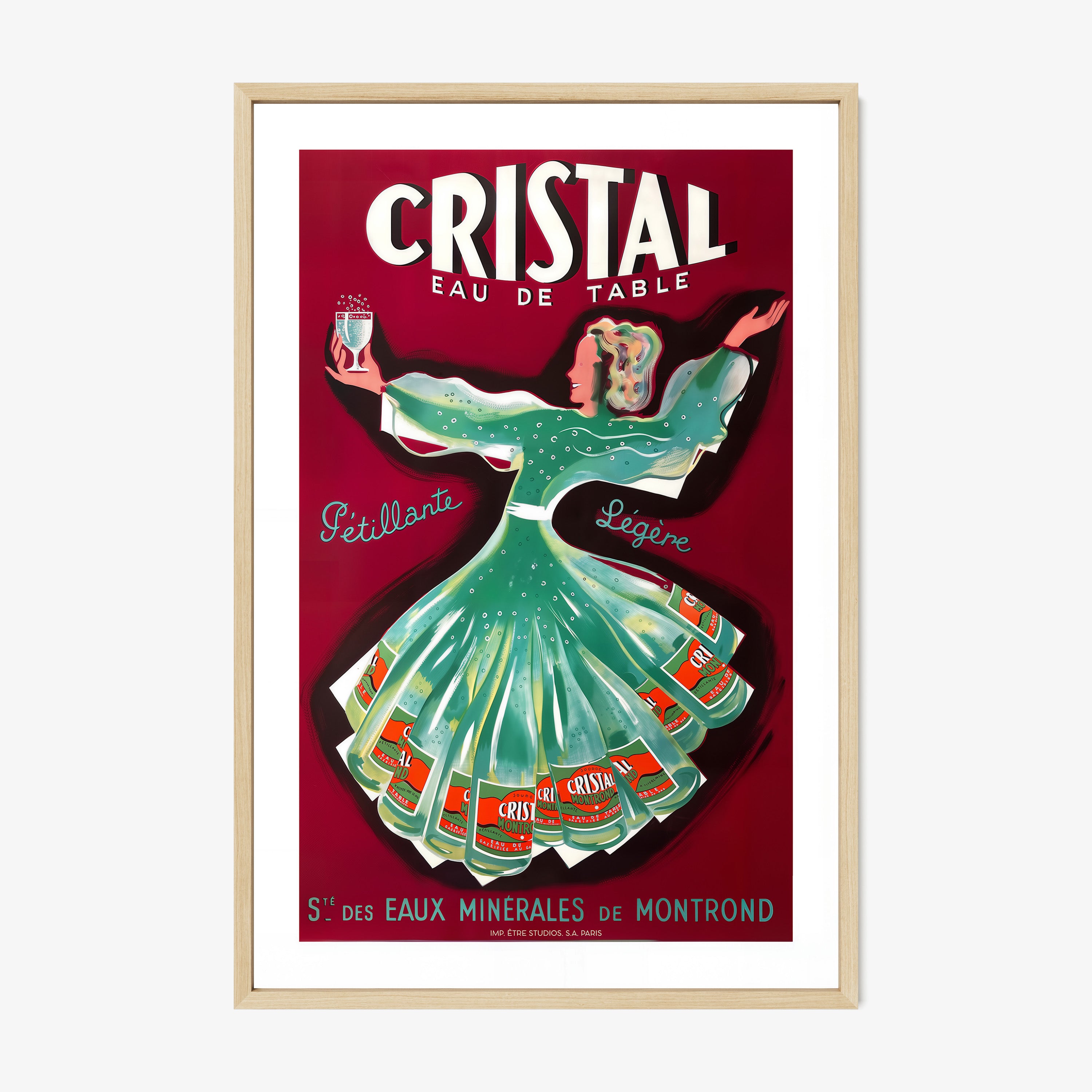 A framed poster features a whimsical woman dancing holding a glass of cristal