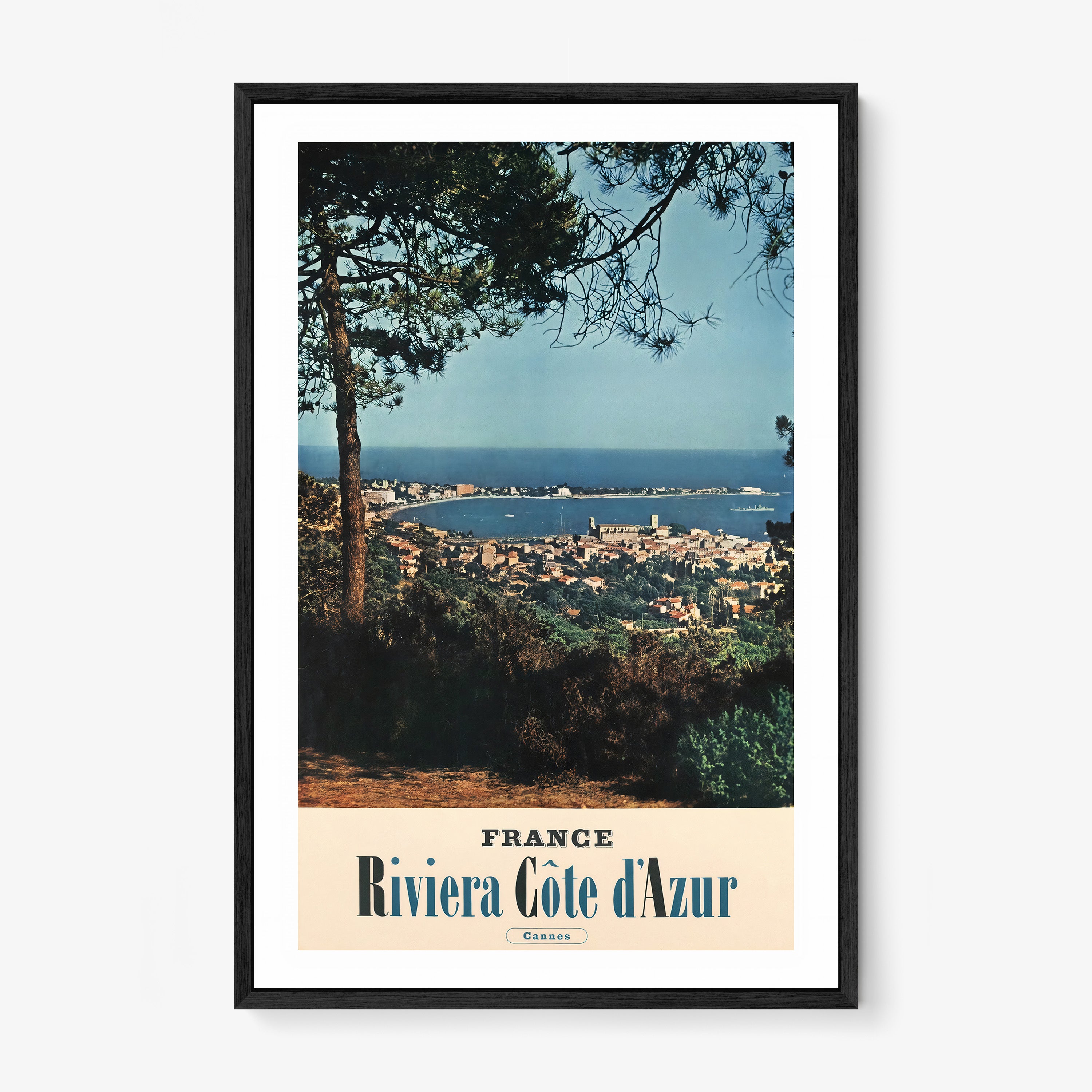 Poster of an ocean and city viewpoint with the text "France Riviera Cote d'Azur" on the bottom hanging on a light background