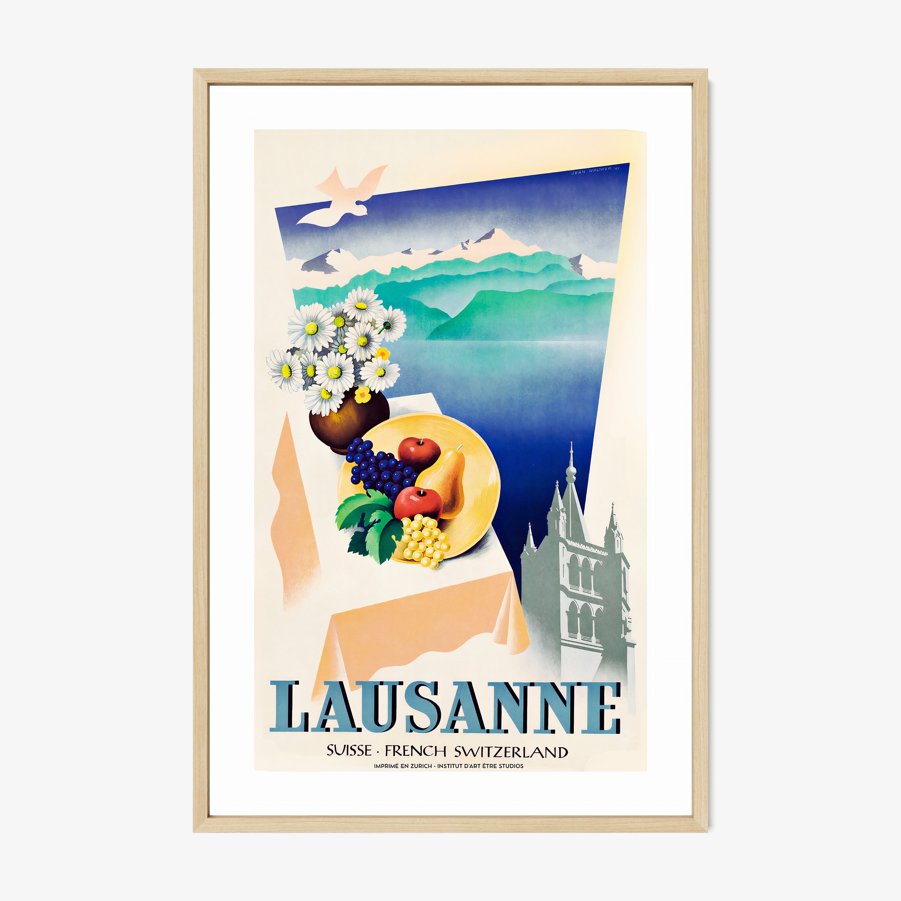 Framed poster of different elements with a mountain lake background and the text "Lausanne" at the bottom hanging on a light background