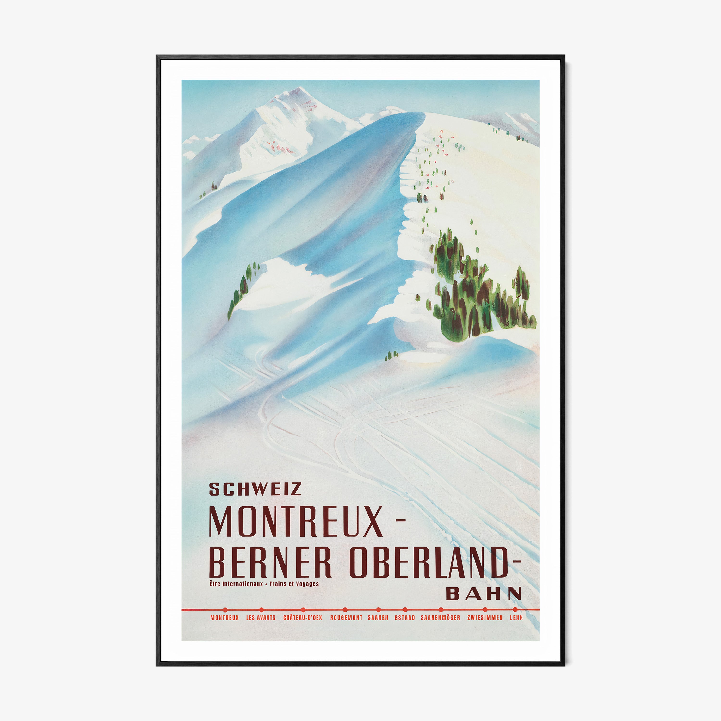 Framed poster featuring a snow covered mountain with the text "Montreux- Berner Oberland" at the bottom hanging on a white background