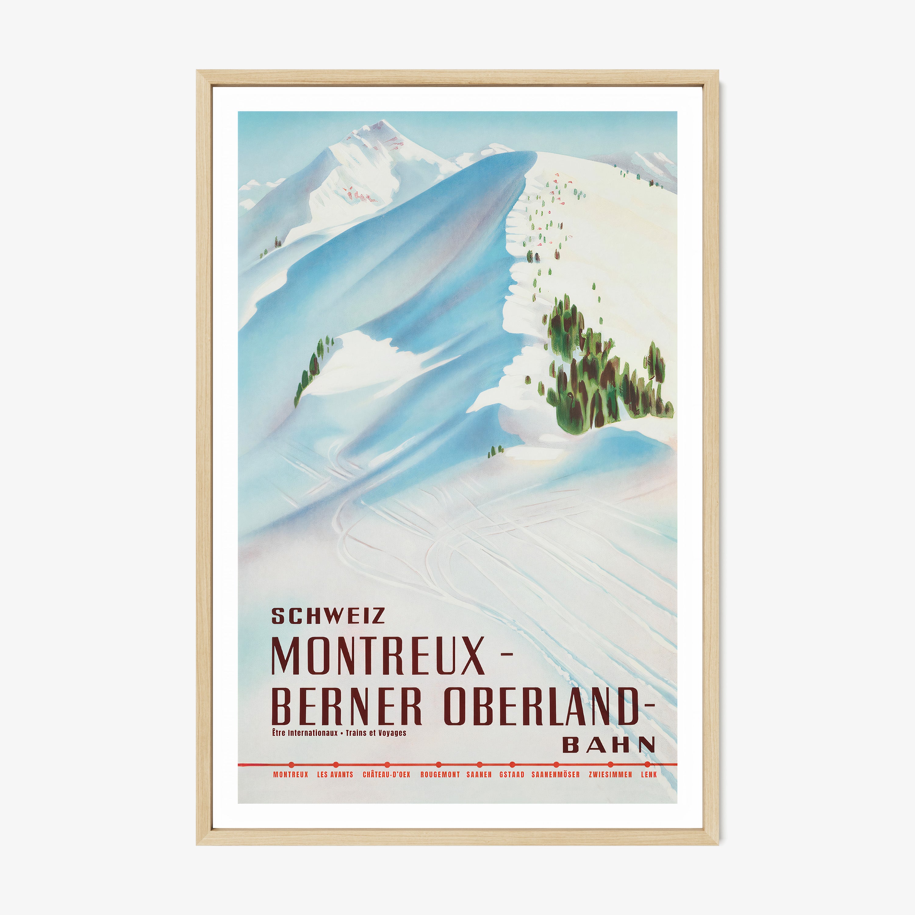 Framed poster featuring a snow covered mountain with the text "Montreux- Berner Oberland" at the bottom hanging on a white background