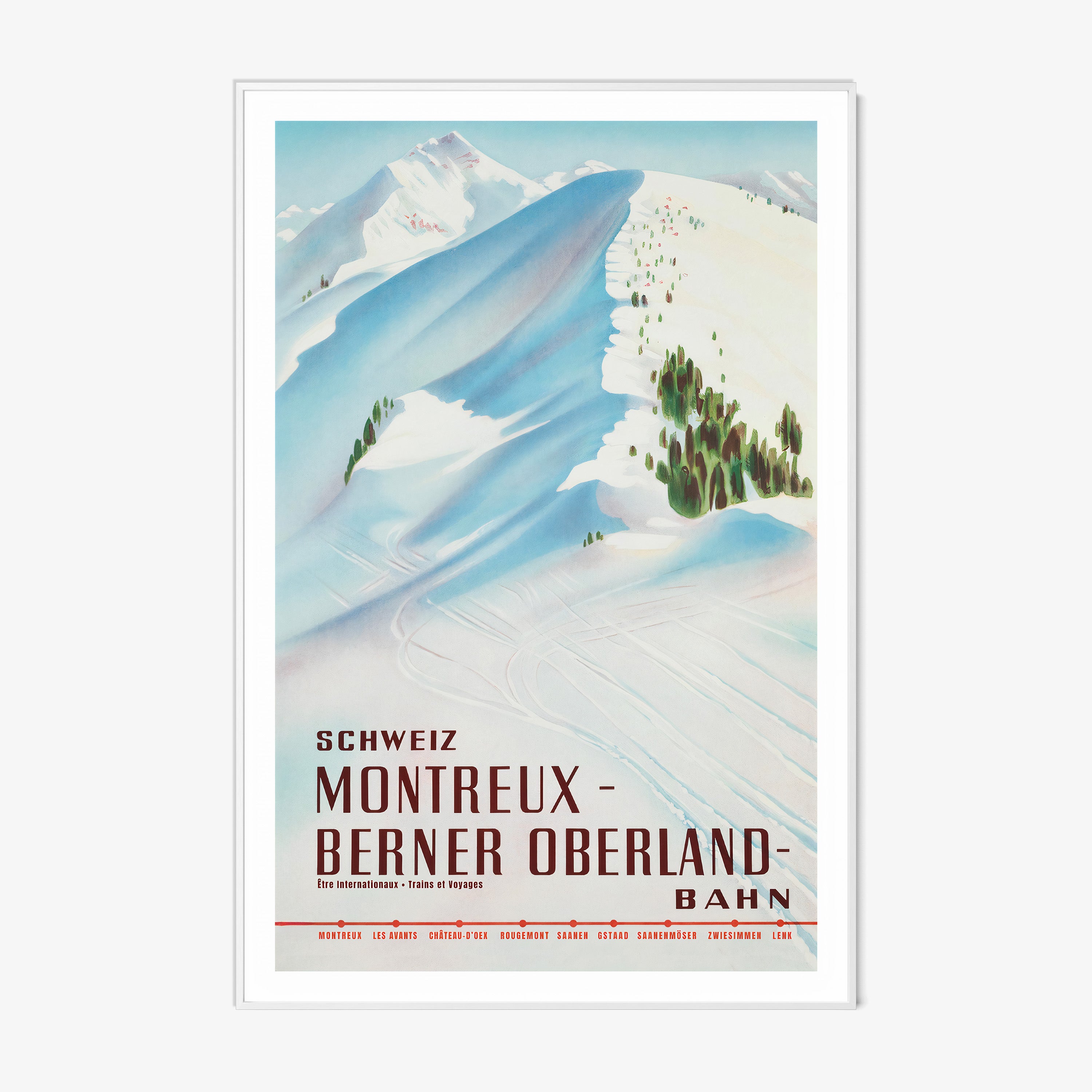 Framed poster featuring a snow covered mountain with the text "Montreux- Berner Oberland" at the bottom hanging on a white background