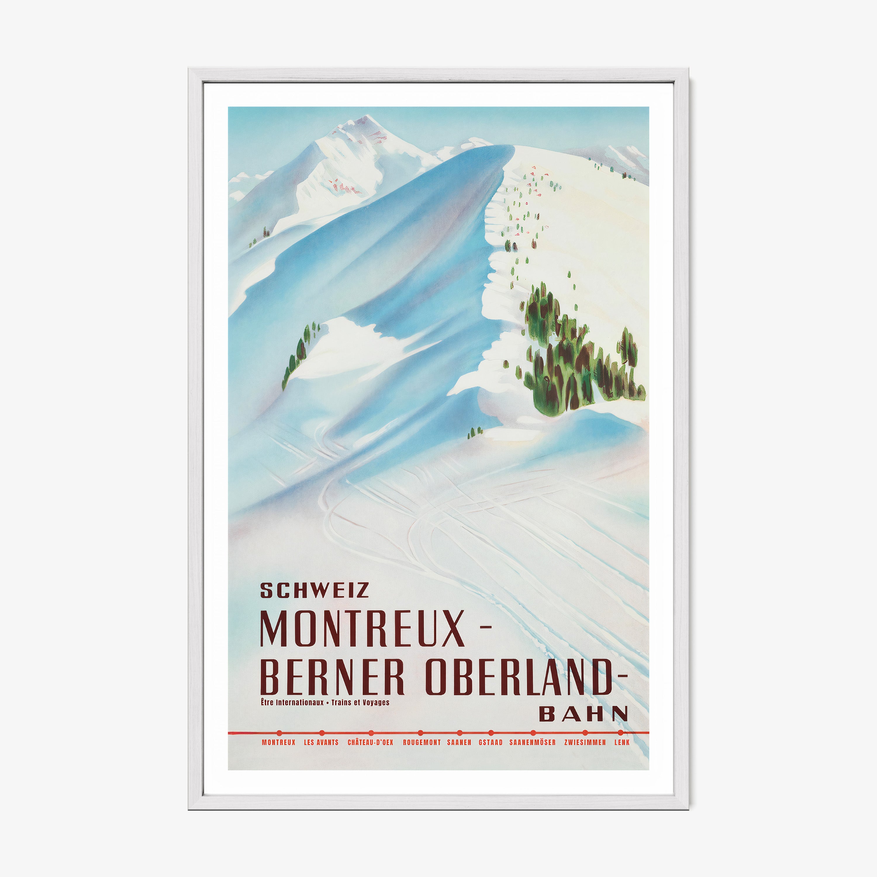 Framed poster featuring a snow covered mountain with the text "Montreux- Berner Oberland" at the bottom hanging on a white background