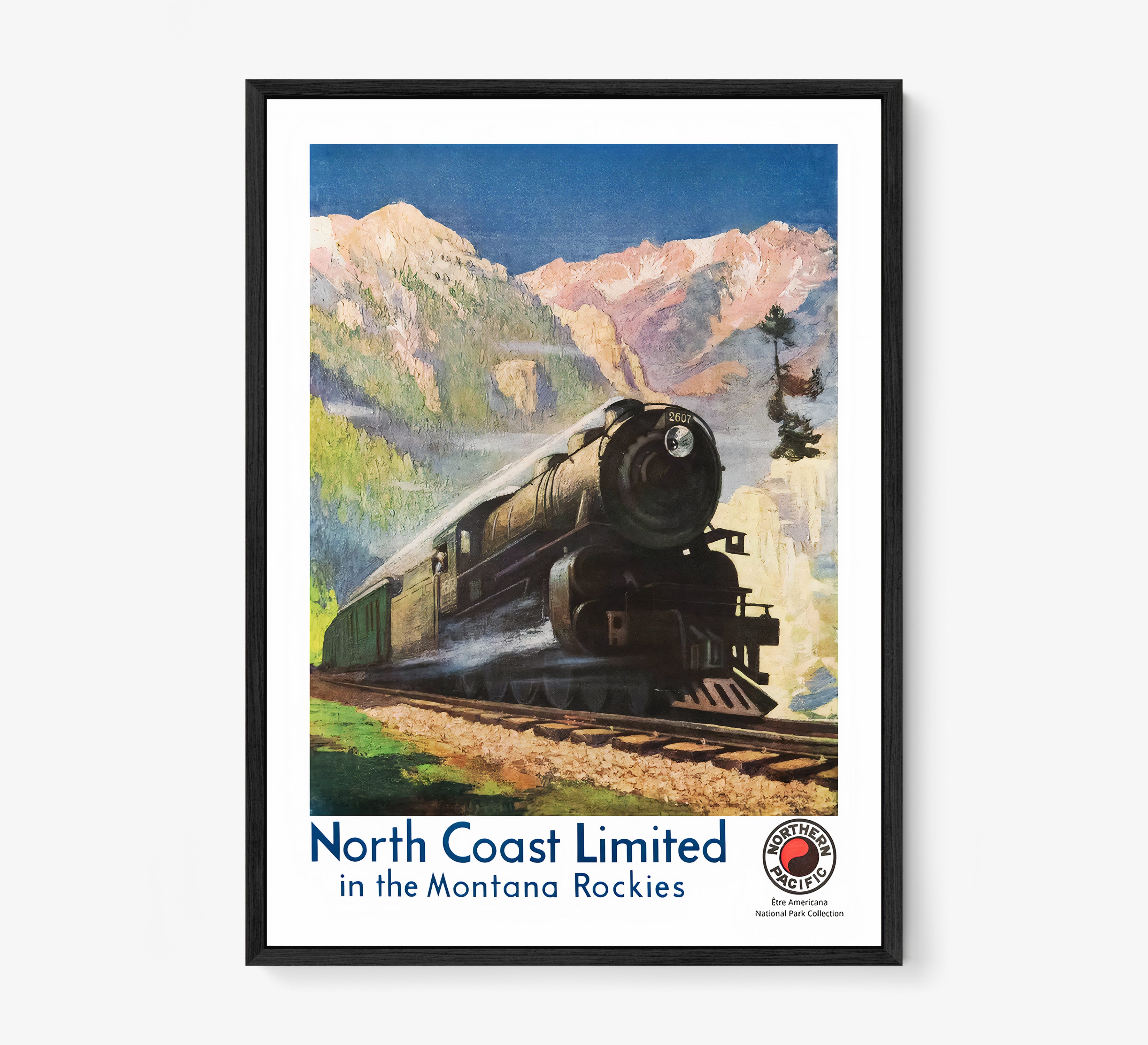 Framed poster of a train speeding through a mountain scene hanging on a light background