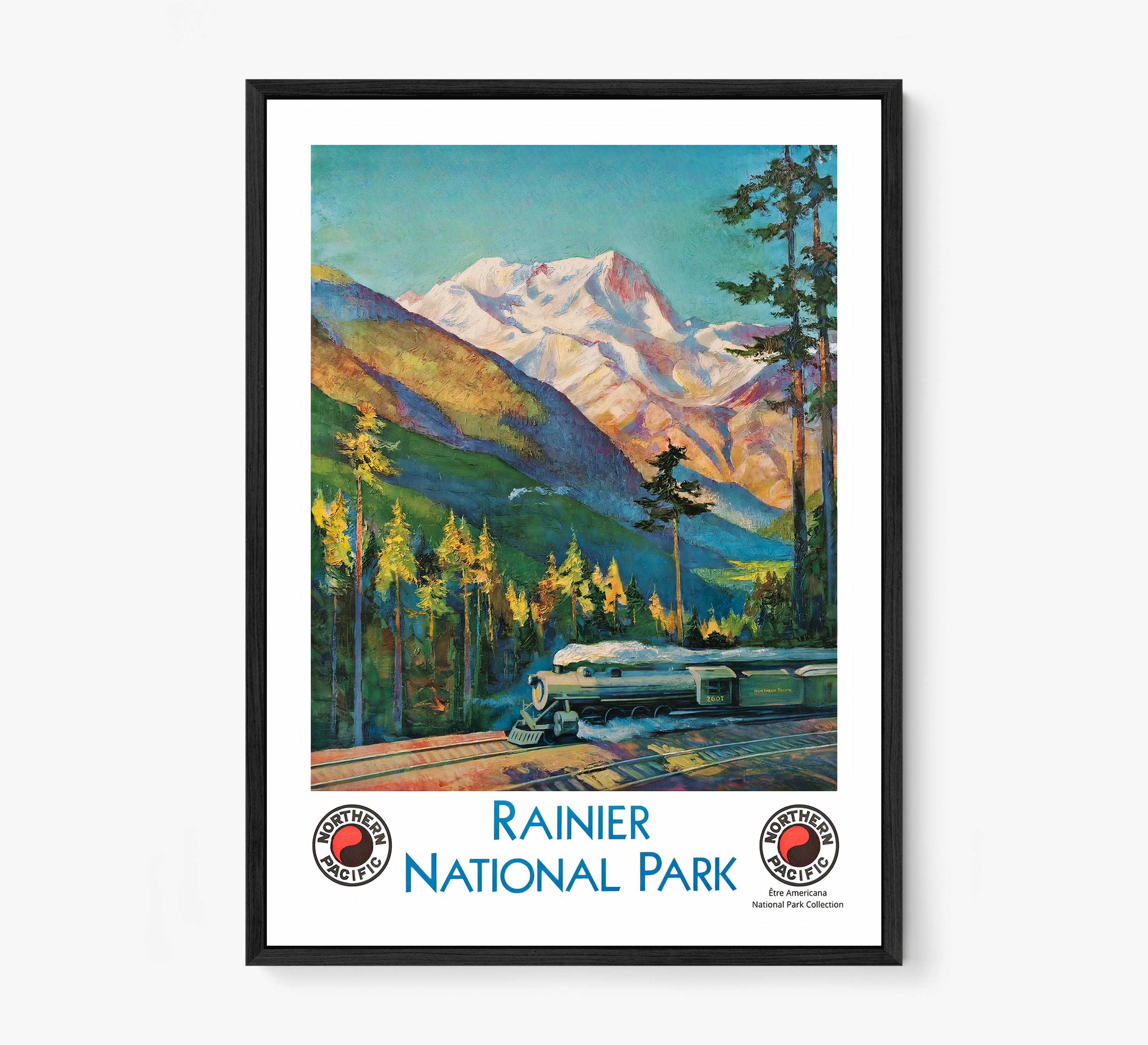 Framed "Rainier National Park" poster featuring a train and mountain scene hanging on a light background