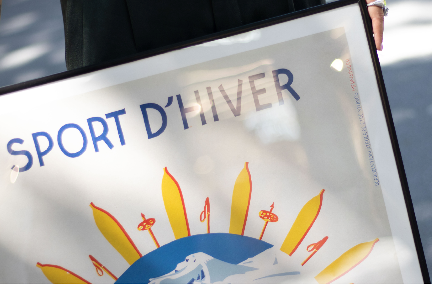 Sign with 'SPORT D'HIVER' and winter sports graphics on a white background