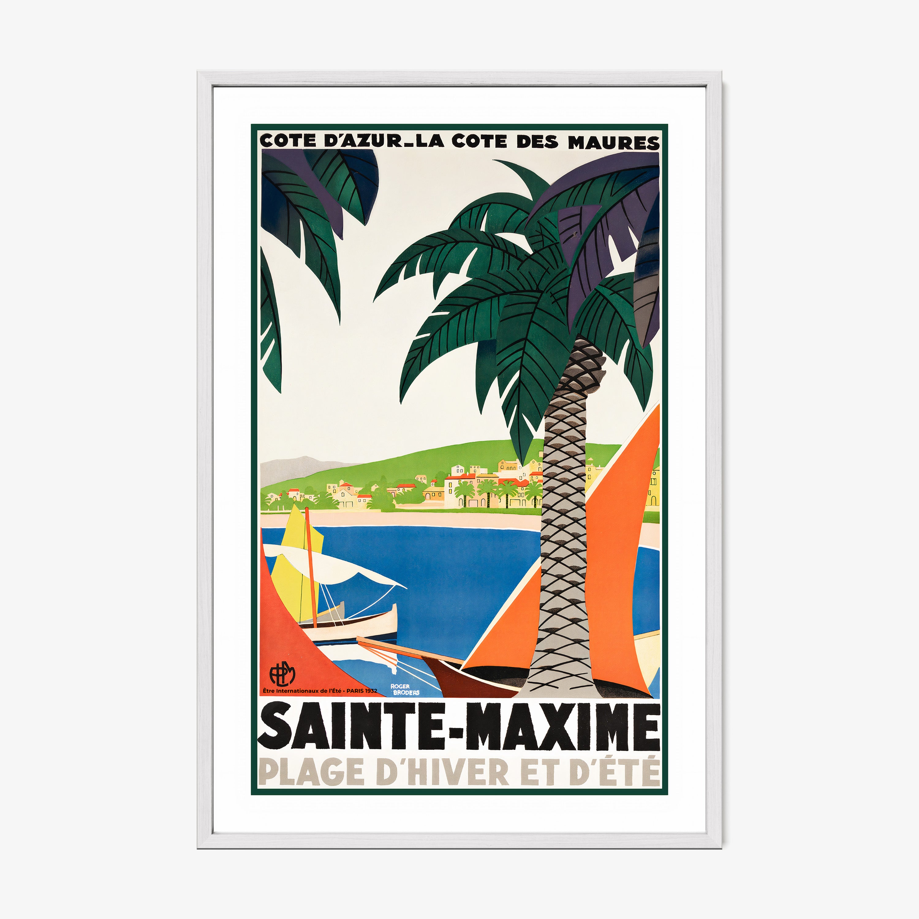 Framed poster featuring sailboats on a blue sea surrounded by palm trees and a coastal village with the text "Sainte-Maxime" at the bottom hanging on a white background
