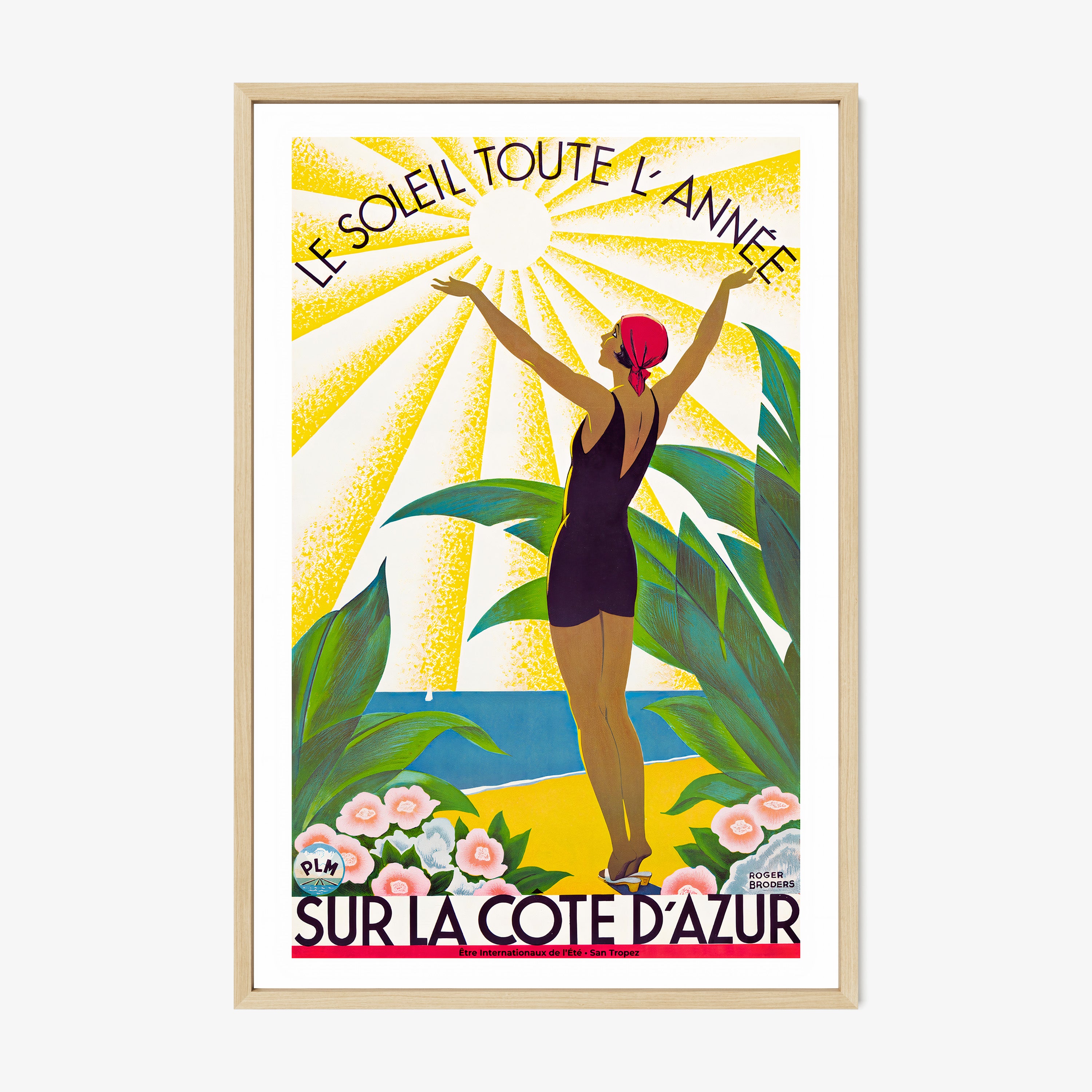 Framed poster of a woman standing with her arms raised to the sun and the text "Sur La Cote D'Azur" at the bottom hanging on a light background