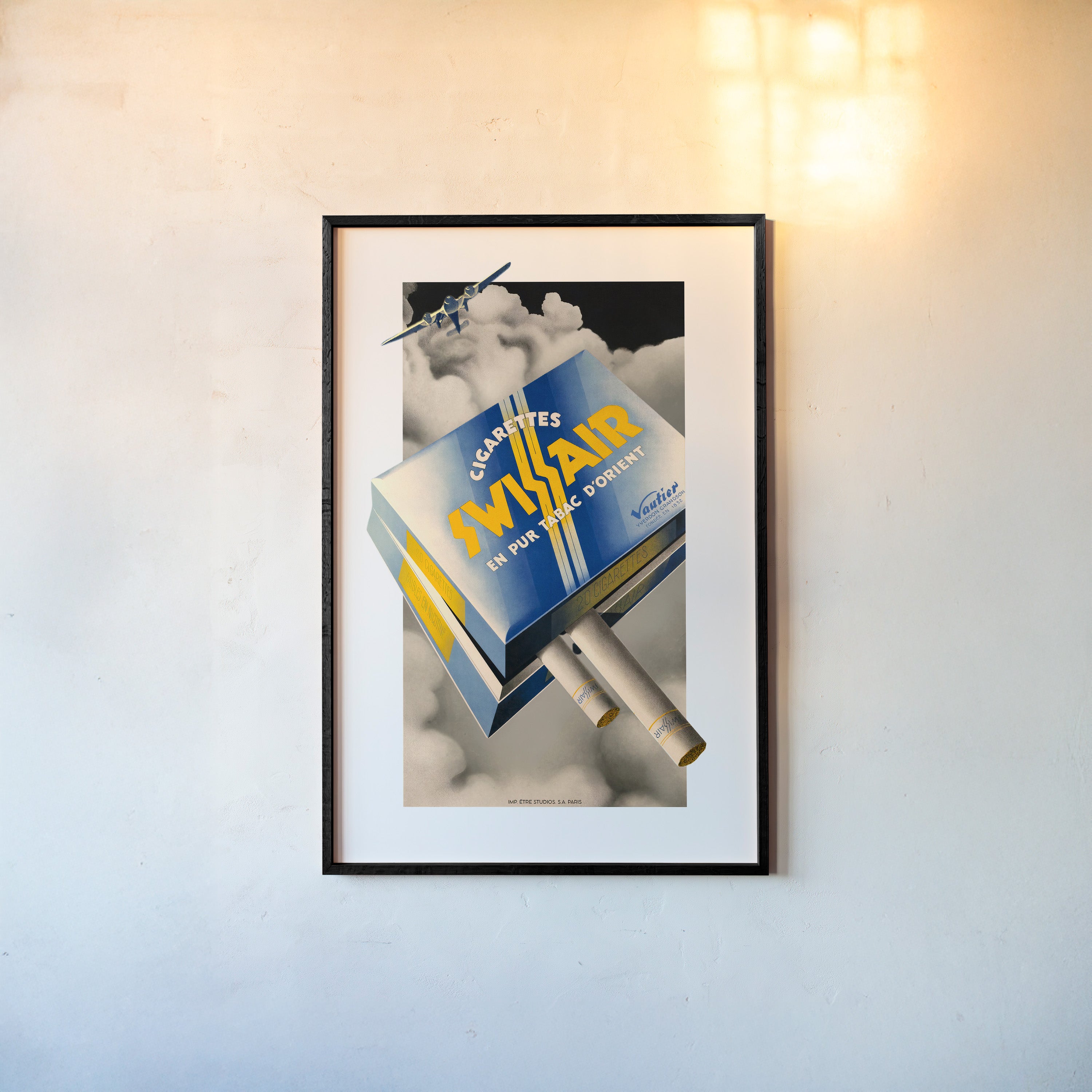 A framed poster features an airline cigarette advertisement 