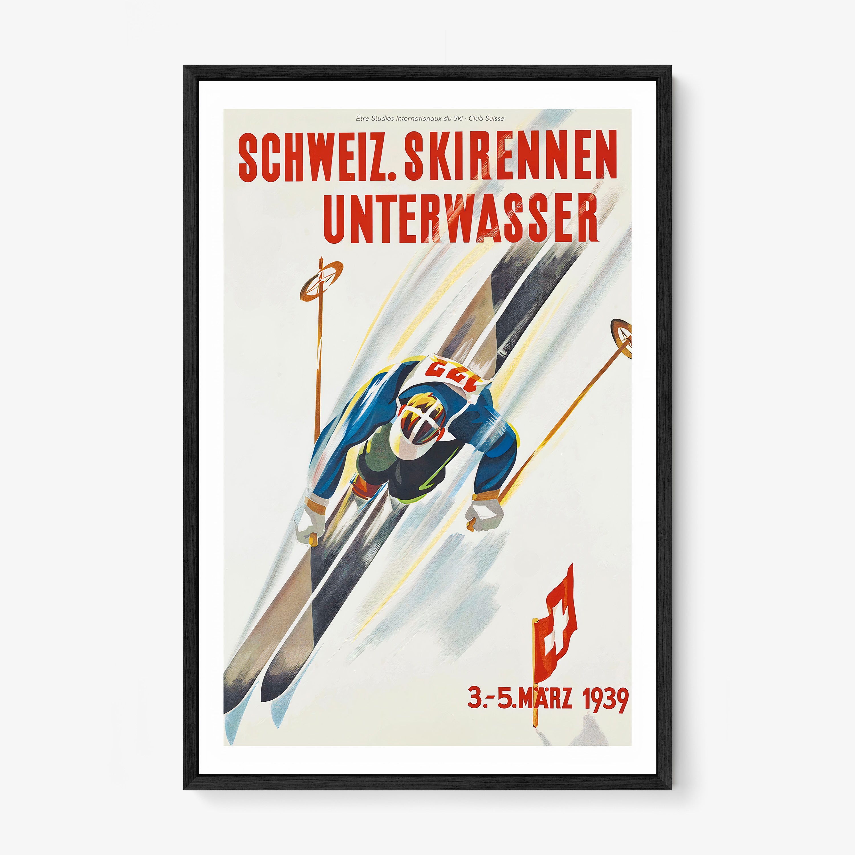 Framed poster of a skier taken from above hanging on a light backdrop