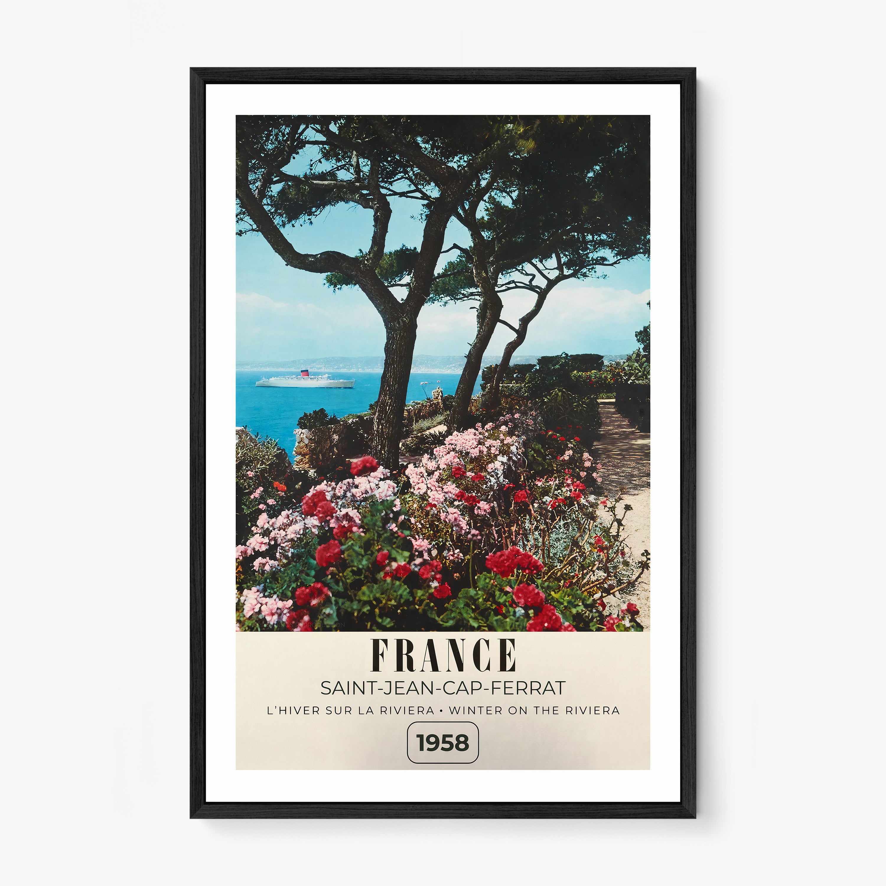 Framed poster of a river with flowers blooming around it and the text "France" in large letters, hanging on a wall with a light background